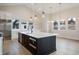 Modern kitchen with large island and stainless steel appliances at 8015 Parnassus Pl, Castle Rock, CO 80108