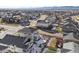 Aerial view of a two-story house with a gray roof, stone exterior, and backyard at 701 Boulder Peak Ave, Erie, CO 80516