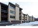 Tan multi-unit building with brown garage doors at 246 Broken Lance Dr # 503, Breckenridge, CO 80424