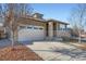 House exterior with landscaping and a driveway at 4655 S Malaya Ct, Aurora, CO 80015