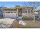 Ranch style home with stone accents and a two-car garage at 4655 S Malaya Ct, Aurora, CO 80015