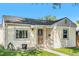 Cute yellow bungalow with front porch and landscaping at 4303 Benton St, Denver, CO 80212