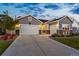 Gray two-car garage craftsman style home with stone accents at 5902 Side Saddle Ln, Parker, CO 80134