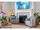 Living room fireplace with whitewashed brick and modern TV at 5902 Side Saddle Ln, Parker, CO 80134