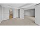 Carpeted bedroom with bathroom access at 4899 S Dudley St # 7H, Littleton, CO 80123
