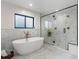 Luxurious bathroom with soaking tub, walk-in shower, and marble tile at 3348 Osage St, Denver, CO 80211