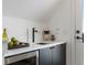 Modern wet bar with a sink, mini-fridge, and white countertop at 3348 Osage St, Denver, CO 80211