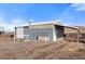 Metal barn with a covered area and loading ramp at 12154 Mesa View Rd, Larkspur, CO 80118