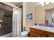 Small bathroom with shower and wood vanity at 12154 Mesa View Rd, Larkspur, CO 80118