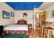 Bedroom with a rustic feel and a blue ceiling at 12154 Mesa View Rd, Larkspur, CO 80118