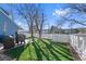 Landscaped backyard with artificial turf and white fence at 8099 S Trinchera Peak, Littleton, CO 80127