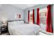 King-size bed in a bright bedroom with red curtains at 638 S Lincoln St, Denver, CO 80209