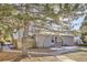 Tan exterior house with wood fence and tree in front at 14543 E 12Th Ave, Aurora, CO 80011