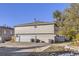 Rear view of house showing double garage and driveway at 14543 E 12Th Ave, Aurora, CO 80011