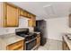 Simple kitchen with wood cabinets and stainless steel appliances at 14543 E 12Th Ave, Aurora, CO 80011