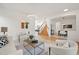 Open living room with a staircase and views into the dining room at 4340 Nelson Dr, Broomfield, CO 80023