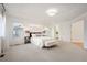 Main bedroom with plush carpet, large windows, and ensuite bathroom access at 4340 Nelson Dr, Broomfield, CO 80023