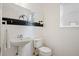 Clean and simple half bathroom with pedestal sink and toilet at 4340 Nelson Dr, Broomfield, CO 80023