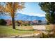 View of golf course with mountain backdrop and golf carts at 4340 Nelson Dr, Broomfield, CO 80023