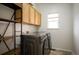 Bright laundry room, washer, dryer, cabinets and shelving at 4340 Nelson Dr, Broomfield, CO 80023