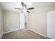 Well-lit bedroom featuring a ceiling fan and access to other rooms at 9180 E Center Ave # 1A, Denver, CO 80247