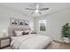 Bright bedroom with large bed, ceiling fan, and window at 15948 Antora Peak Dr, Broomfield, CO 80023