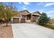 Two-story house with a two-car garage, stone accents, and a covered porch at 4763 Gould Cir, Castle Rock, CO 80109