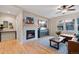 Living area with fireplace, hardwood floors, and a large TV at 4763 Gould Cir, Castle Rock, CO 80109