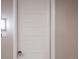 White front door with a sleek handle and number 302 at 12983 W Ida Ave # 302, Littleton, CO 80127