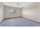 Bright bedroom with ceiling fan, carpet, and window offering a view at 8777 Selly Rd, Parker, CO 80134