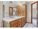 Double vanity bathroom with wood cabinets and tile flooring at 8777 Selly Rd, Parker, CO 80134