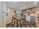 Quaint basement kitchen with colorful cabinets and a breakfast bar at 1400 S Vine St, Denver, CO 80210