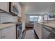 Modern kitchen features stainless steel appliances and white cabinetry at 2765 S Lincoln St, Englewood, CO 80113