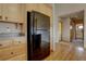 Kitchen with black refrigerator and light wood cabinets at 9784 W Euclid Dr, Littleton, CO 80123