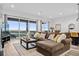 Open concept living room with comfortable seating and large windows at 3010 Newfound Lake Rd, Berthoud, CO 80513