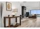 Bright and airy entryway with wood console table and view to living room at 3010 Newfound Lake Rd, Berthoud, CO 80513