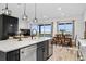 Open kitchen with island, stainless steel appliances, and view to dining area at 3010 Newfound Lake Rd, Berthoud, CO 80513