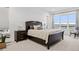 Main bedroom with large windows, plush bedding, and dark wood furniture at 3010 Newfound Lake Rd, Berthoud, CO 80513