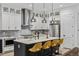 Modern kitchen with white cabinets, stainless steel appliances and large island at 3010 Newfound Lake Rd, Berthoud, CO 80513
