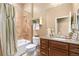 Bathroom with shower/tub combo, granite vanity, and updated fixtures at 4640 Belford Cir, Broomfield, CO 80023