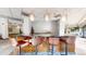 Modern community kitchen features a breakfast bar with leather stools at 100 Park W Ave # 608, Denver, CO 80205