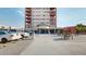 Building exterior with parking and patio seating at 100 Park W Ave # 608, Denver, CO 80205