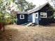 Charming dark blue house with a yard and small steps leading to the entrance at 230 Emery St, Longmont, CO 80501