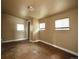Simple bedroom with tiled floors and multiple windows at 230 Emery St, Longmont, CO 80501