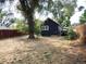 Dark blue house with a large tree in the backyard at 230 Emery St, Longmont, CO 80501