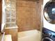 Updated bathroom with tub, shower, and laundry hookups at 230 Emery St, Longmont, CO 80501