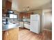 Efficient kitchen featuring wood cabinets and appliances at 230 Emery St, Longmont, CO 80501