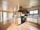 Open kitchen with wood cabinets and black appliances at 230 Emery St, Longmont, CO 80501