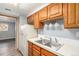 Kitchen with wood cabinets, stainless steel sink and appliances at 12191 Melody Dr # 102, Westminster, CO 80234