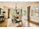 Formal dining room with hardwood floors, large windows, and elegant chandelier at 1348 Chapel Royal Ct, Monument, CO 80132